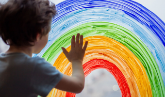 niño tocando un arco iris